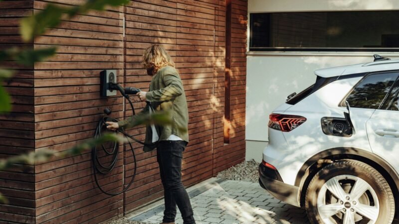 a woman is using a power washer on a brick wall